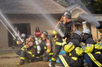 ホースから放水する消防団員達の写真